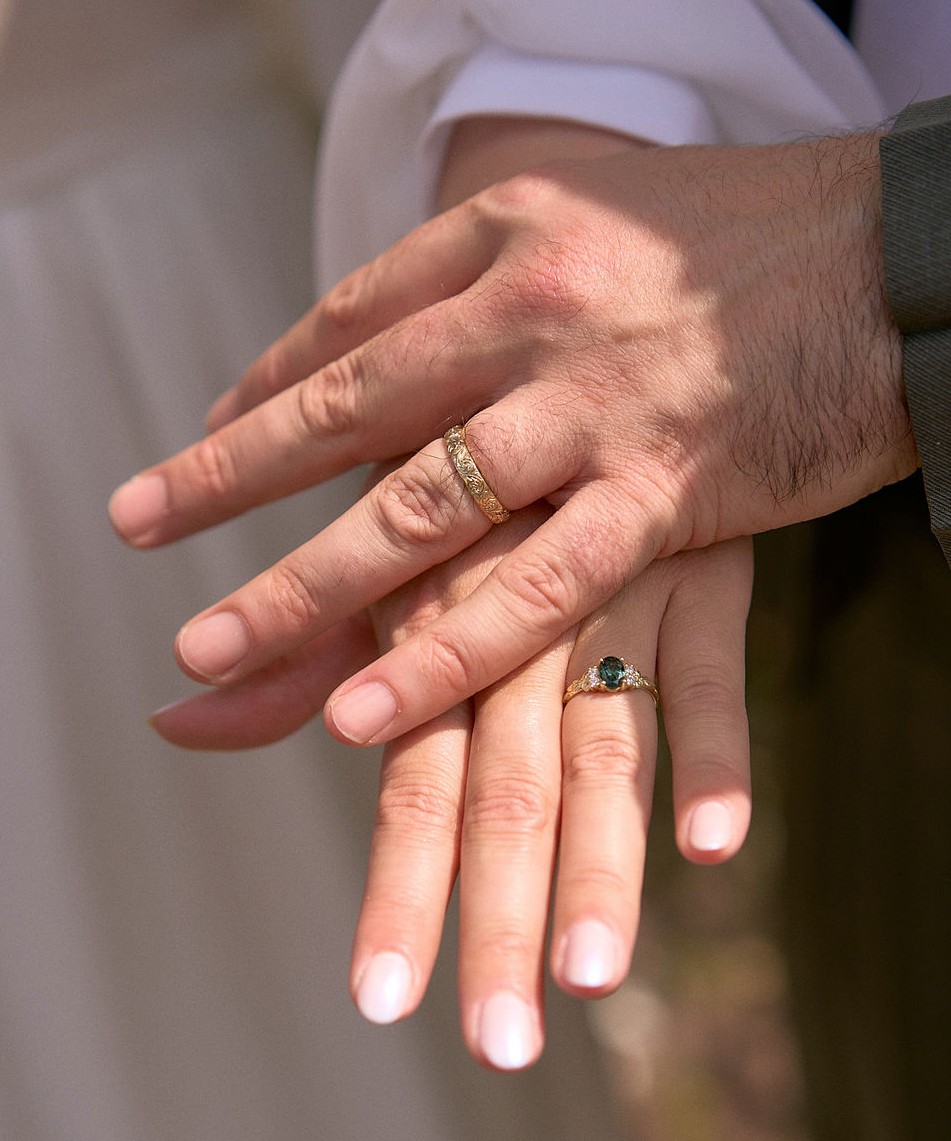 Close up of married couple's hands giving knuckles.